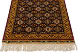 Angled corner view showing the lustrous full pile, geometric gold border, and ivory fringe.