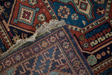 A view of the hand-knotted back, original selvage, and plush pile of the vintage rug.