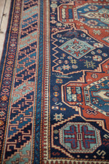 Dynamic stepped geometric border and navy blue field of a lustrous vintage hand-knotted Indian rug.
