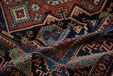 High luster pile with rich color saturation on a vintage Indian rug with geometric Caucasian motifs.