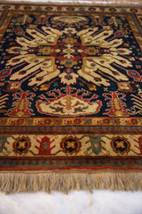Fringe and geometric borders in ivory, rust, navy of a vintage Indian Kazak rug.
