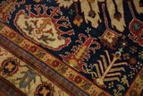 Vintage Indian Kazak rug: navy blue field with rust floral blossoms and gold border.