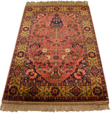 Vintage Bakhtiari tree-of-life design with navy vase, dusty red field, gold floral vines.