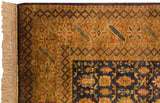Lustrous vintage Indian Caucasian rug corner, showing golden geometric border, navy floral field, and fringe.