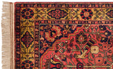 Corner of a vintage Bakhtiari rug with a perched bird, gold border, and ivory fringe.
