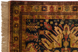 Kazak rug corner detail with intact fringe, side cord, and navy-rust-gold floral motifs.