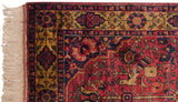 Corner of vintage Indian Bakhtiari rug with ivory fringe, red selvage, floral border.