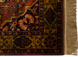 Corner detail shows the rich floral border, lush pile, and thick fringe.