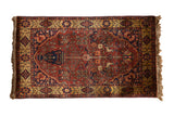 Vintage Indian Bakhtiari design rug with a tree-of-life, vase, and bird motif in red, navy, and gold.