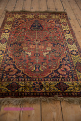Angled view of a vintage Indian Bakhtiari rug showing its lustrous pile and fringe.
