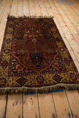 Vintage Indian Bakhtiari rug angled to show its silk-like sheen and rich red and gold colors.