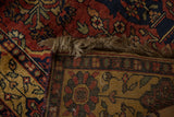 A corner of the vintage Indian rug folded back to show its hand-knotted foundation and secured end.