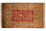 Vintage Indian Caucasian Chi-Chi design rug with deep black cherry red field and saffron yellow geometric borders.