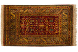 Vintage Indian Caucasian rug corner showcasing lustrous red, saffron, gold Chi-Chi geometric motifs and fringe.