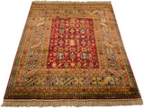 Vintage Indian rug corner with lustrous deep red field, geometric borders, and fringe.