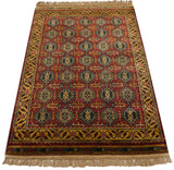 Angled view of a vintage Indian rug with a dense, lustrous pile and a geometric Caucasian pattern.