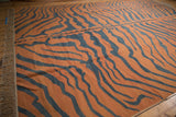 Vintage Tiger Kilim carpet featuring rust-orange and dusty charcoal abrashes and intact fringe.