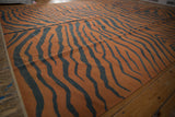 Flatweave texture of the Indian Tiger Kilim with dramatic rust and charcoal stripes.