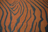Tiger stripe pattern of vintage Kilim carpet in pale rust and dark charcoal with abrashes.