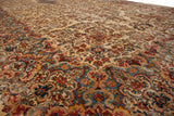 Dense floral bouquets and vines across the full, even pile of a vintage Kerman carpet.