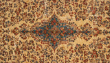 A vintage Kerman carpet's sky blue center medallion surrounded by detailed millefleur bouquets.