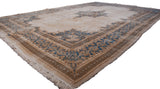 Ivory Kerman carpet, blue Rococo medallion, and a golden floral cross-section border.