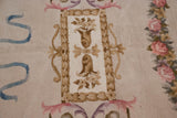 Spanish Savonnerie rug detail: beige floral cartouche, powder blue ribbons, and blush rose border.