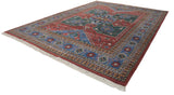 Hand knotted Indian Northwest Persian rug corner with brick red, blue, and green geometric motifs.