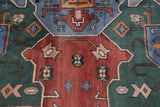 Brick red, mallard green geometric relief and splayed medallion contour on vintage Indian carpet.