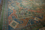 Geometric border and green-tinted fringe of the vintage Indian Caucasian design rug.