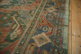 Intact green selvage and geometric border of vintage Indian Caucasian rug in celadon, blue, rust.