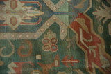 Vintage Indian Caucasian rug pile detail with shades of green, rust, and blue arabesque motifs.