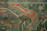 Vintage Indian Caucasian rug close-up: tea-washed green, blue, and terracotta stylized motifs.