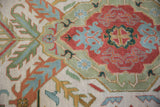 Full pile of vintage Indian Caucasian rug, showing rust, seafoam, ivory floral motifs.