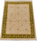 Diminutive gold pearl medallions and olive border define this Indian Art Deco carpet.