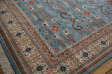 Intricate blush and ivory borders with Perpedil motif on a deep powder blue field and fringe.