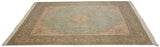 Angled perspective on a vintage square carpet with a soft mint green field and ivory medallion.