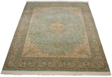 Angled view of a vintage Kerman design carpet with a mint green millefleur field and ivory medallion.