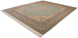 Angled view of a vintage Bulgarian square carpet with a mint green field and intricate floral borders.