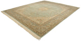 Vintage Kerman design carpet viewed at an angle, showing the mint green field and complex Rococo borders.