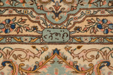 Weaver's signature detail woven in a mint green cartouche on a vintage Bulgarian Kerman carpet.