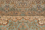The weaver's signature within a cartouche on a vintage Bulgarian carpet's floral border.