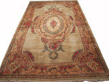 Vintage Kerman carpet's ornate rose bouquets, European-style medallions, and beige and cochineal palette.