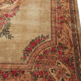Kerman carpet detail: ornate floral design with red roses, green leaves, and sky blue border.
