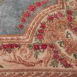 Fine Kerman carpet detail: cochineal red rose bouquets, ivory European scrolling, and sky blue field.