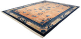 Vintage Peking carpet viewed from an angle, showing the pale copper field, detailed blue borders, and ivory fringe.