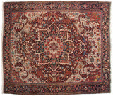 A vintage Heriz carpet's large central medallion, ornate spandrels, and gem-like color palette.