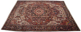 A collector's vintage Heriz carpet viewed from an angle, displaying the symmetry of its central medallion and spandrels.