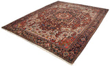 Angled view of a traditional Persian Heriz carpet showing its complex medallion and gem-like color palette.