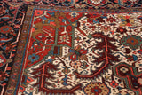 Oversized serrated leaf motif in the corner spandrel of a Collector Heriz rug with full pile.